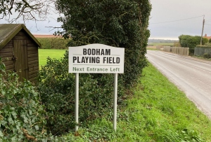 Bodham Playing Field sign on road, Bodham, North Norfolk, UK