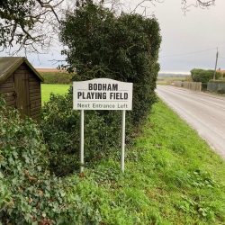 Bodham Playing Field sign on road, Bodham, North Norfolk, UK